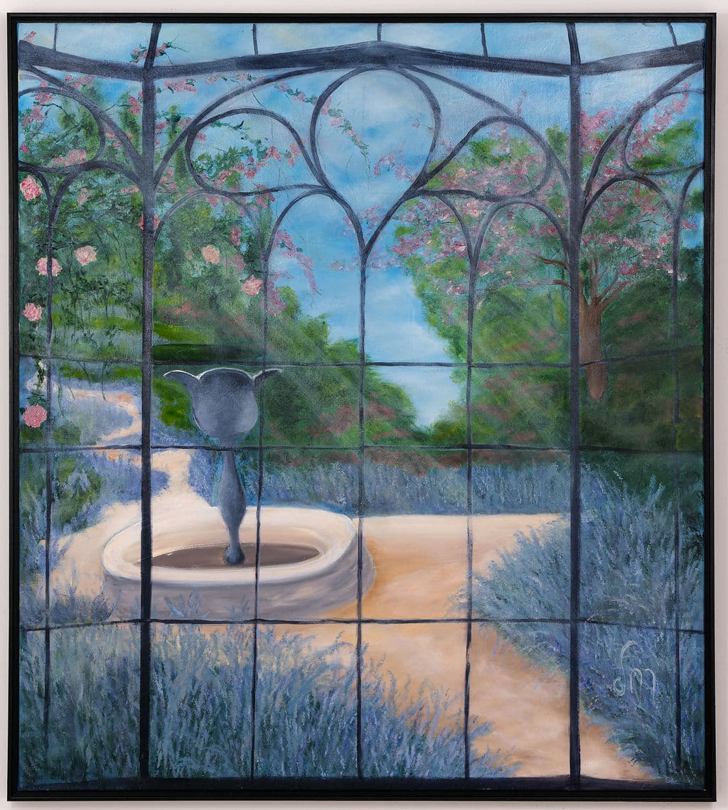 Painting of a garden seen through an arched iron window: a stone fountain, lavender beds, roses and a blossoming tree