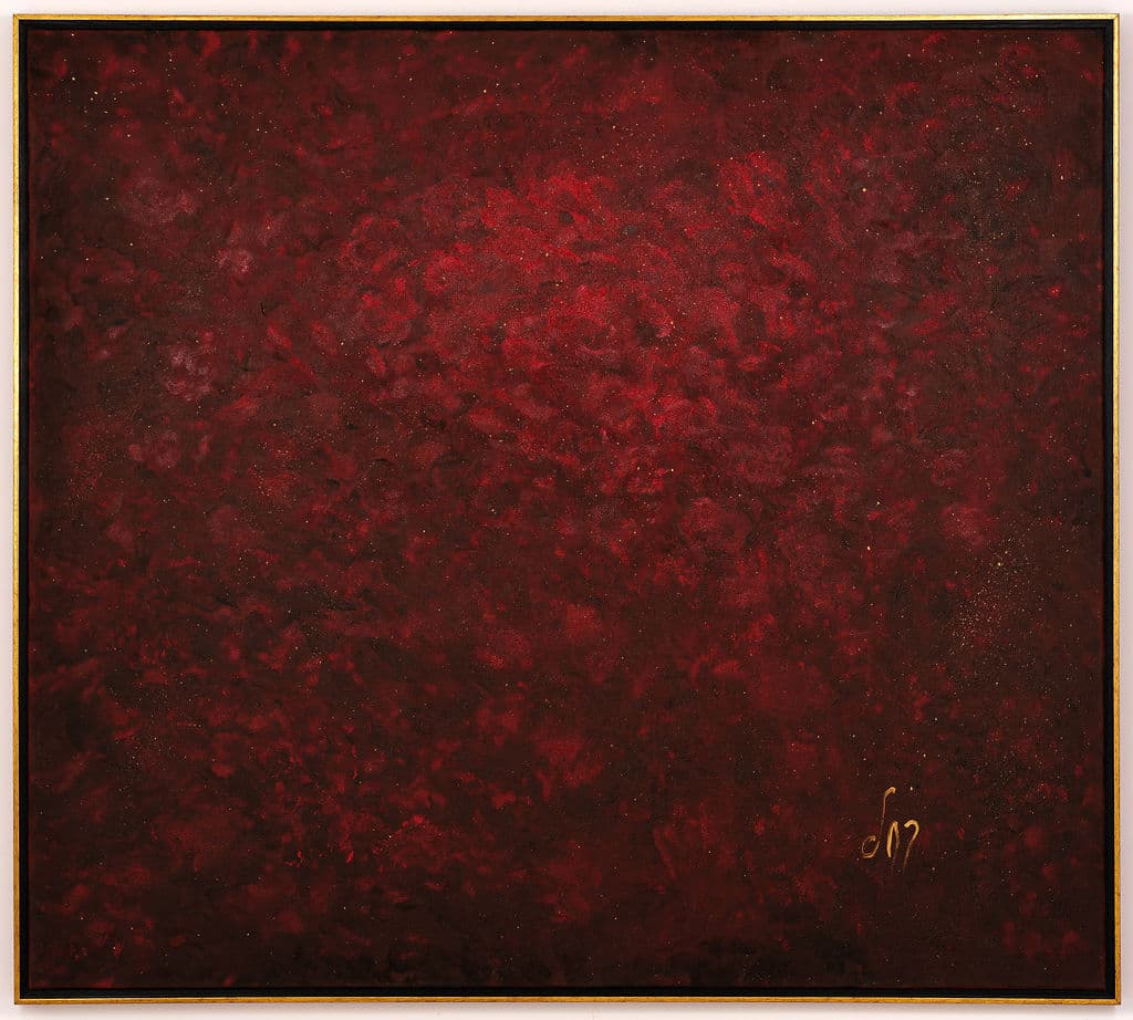 Monochrome abstract painting in deep crimson and burgundy, with a mottled, velvety texture and a lighter red center